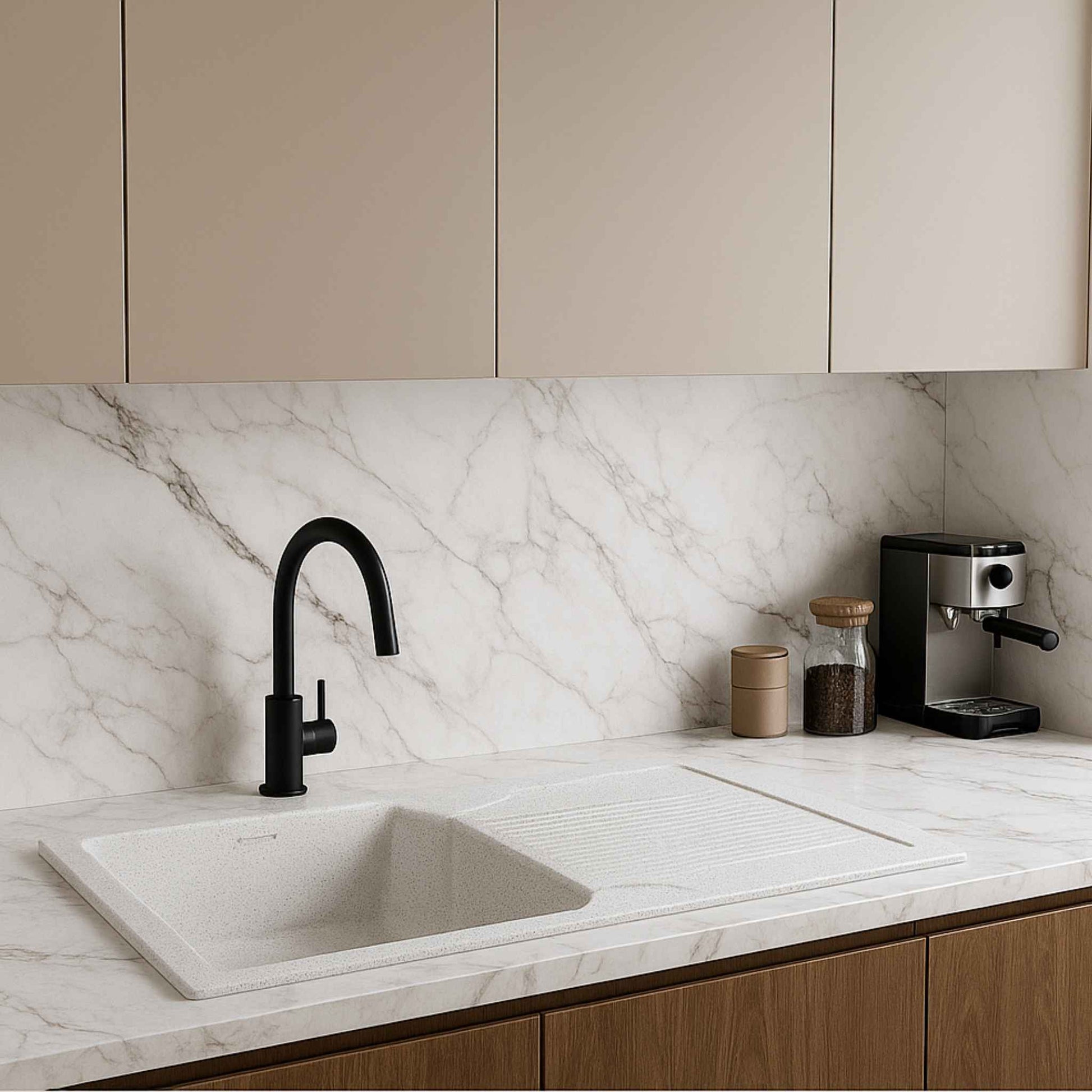 Modern kitchen view with Alaska white granite sink as focal point, set in white marble with minimalist design