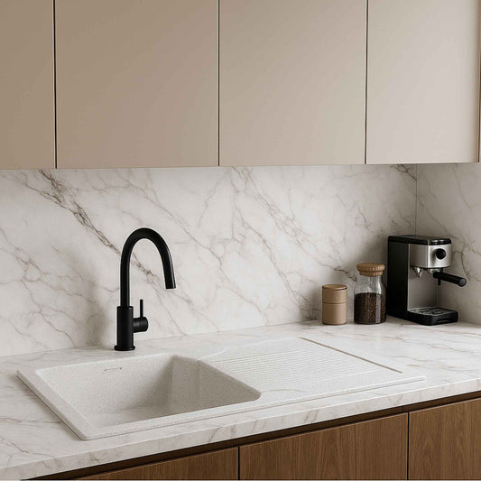 Modern kitchen view with Alaska white granite sink as focal point, set in white marble with minimalist design