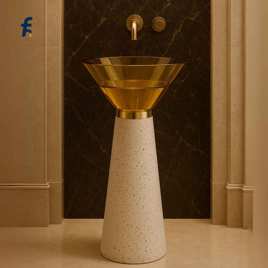 Gold pedestal sink with marble wall in the background