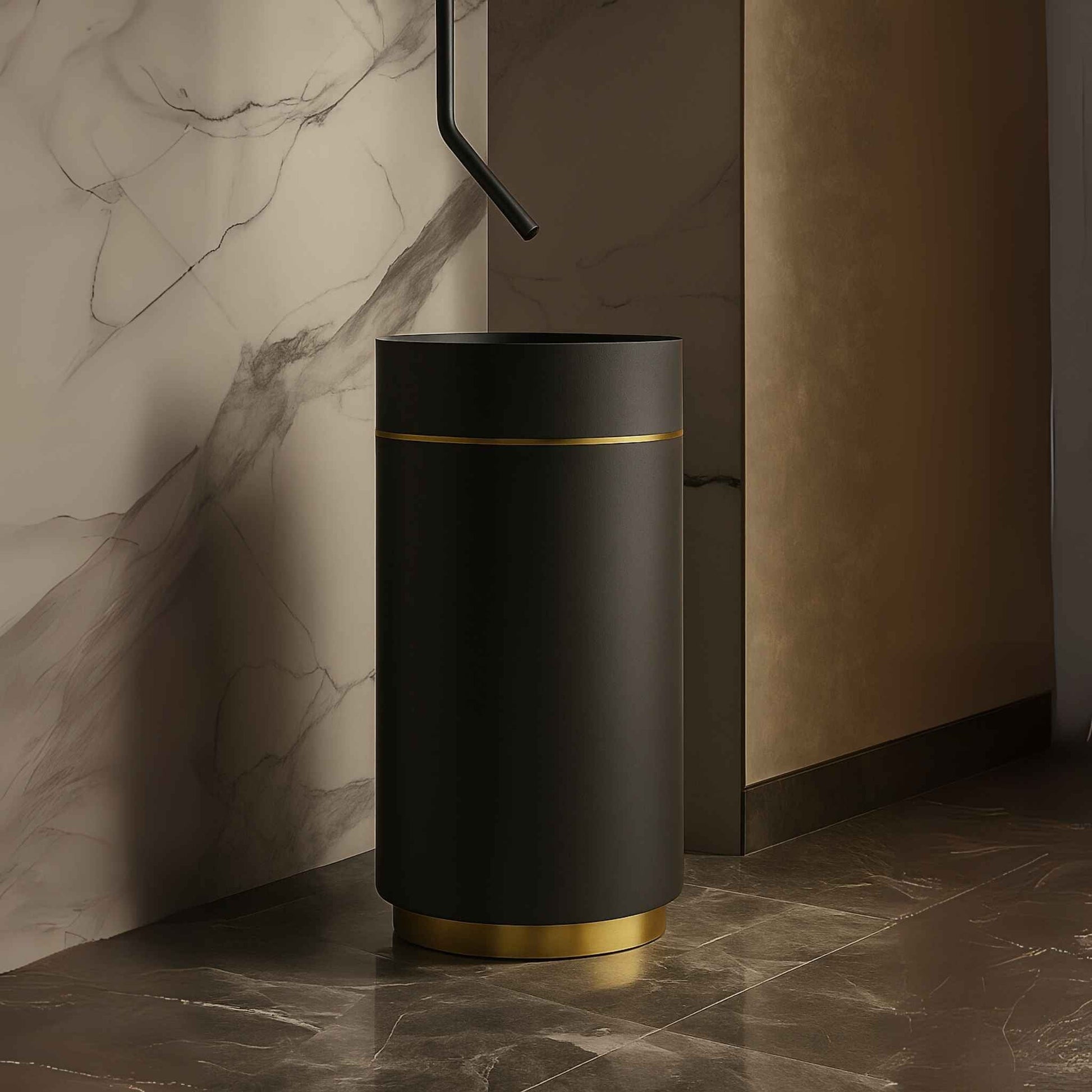 Side angled view of black and gold pedestal basin placed in a high-end bathroom with marble walls and luxury lighting