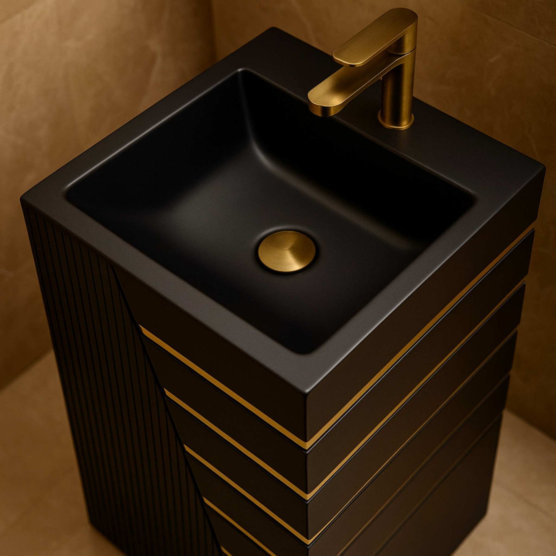 Top view of black pedestal basin with square sink and gold faucet