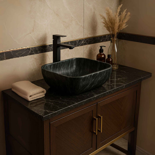 Side angle of black rectangular ceramic wash basin with marble veins on vanity counter