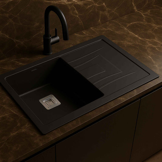 Side angle of a 36x18x9 inch black metallic quartz kitchen sink with ultra-luxurious faucet and Italian marble countertop