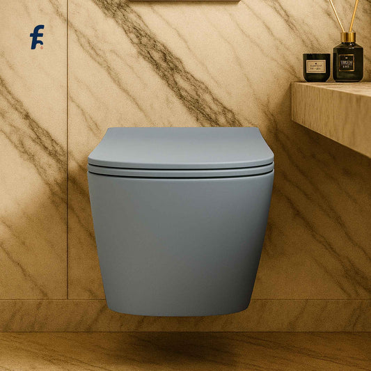 Front view of luxury matte blue wall hung toilet in marble bathroom