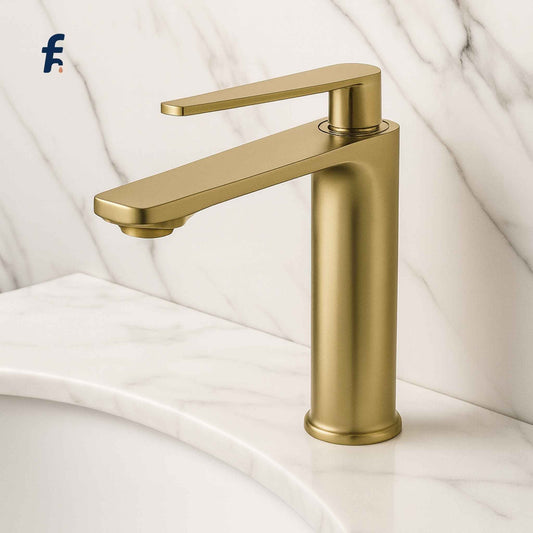 Gold faucet on a white marble background, Brushed gold tall basin faucet front view