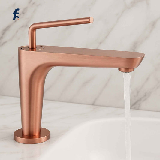 Rose gold faucet on a white background, Brushed rose gold bathroom faucet front view on luxury marble countertop