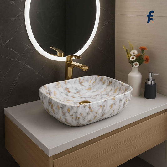 front close-up of marble texture basin with gold drain
