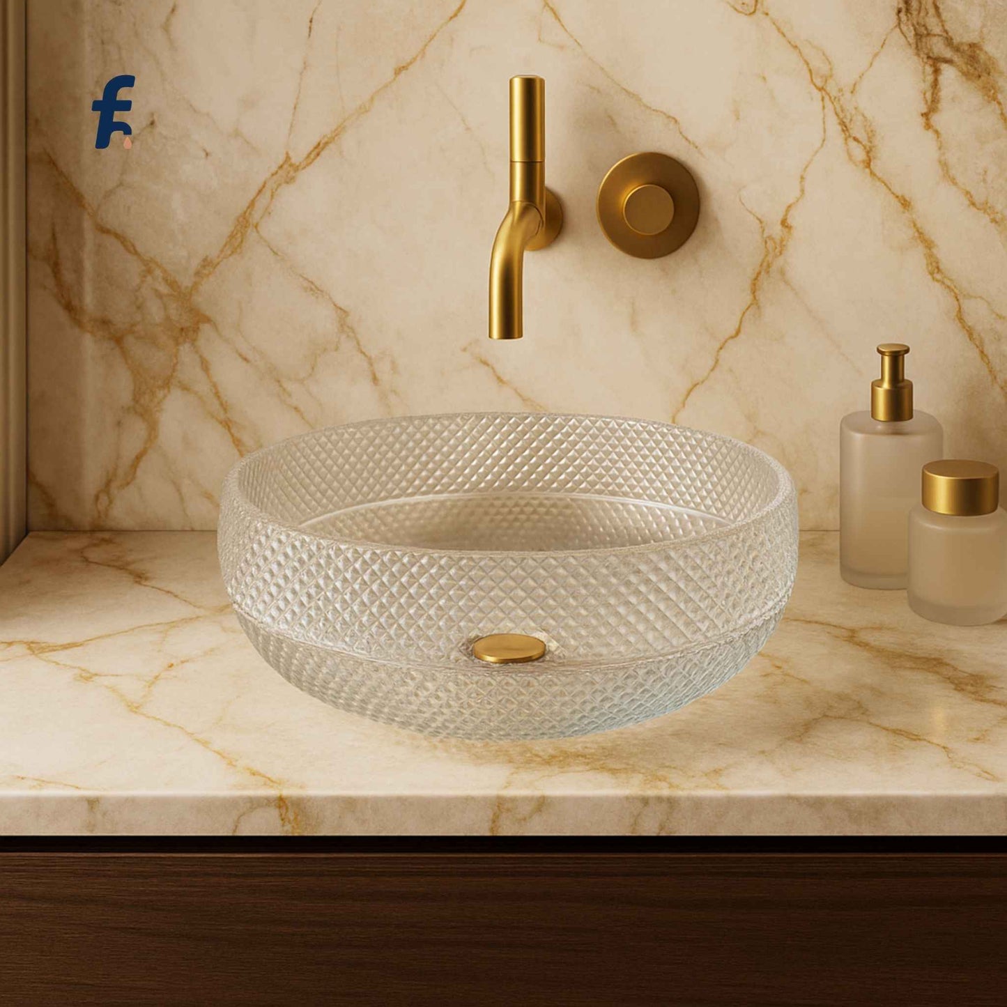 Glass sink with gold fixtures on a marble countertop