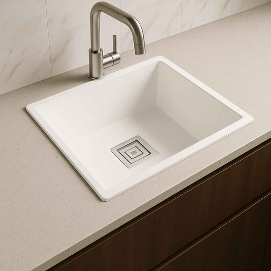White metallic kitchen sink installed in light grey quartz countertop