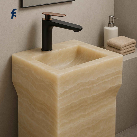 Beige stone sink with black faucet in a bathroom setting