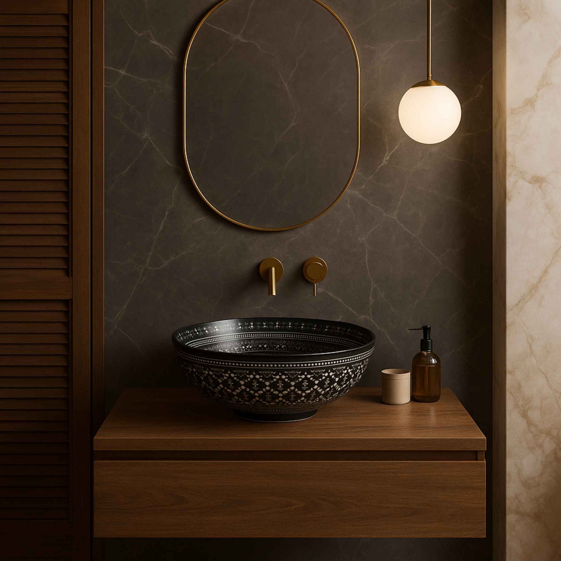 Bathroom vanity with black decorative sink, gold fixtures, and a pendant light.
