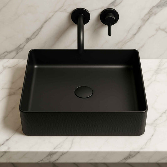 Black square sink with black faucet on a marble countertop