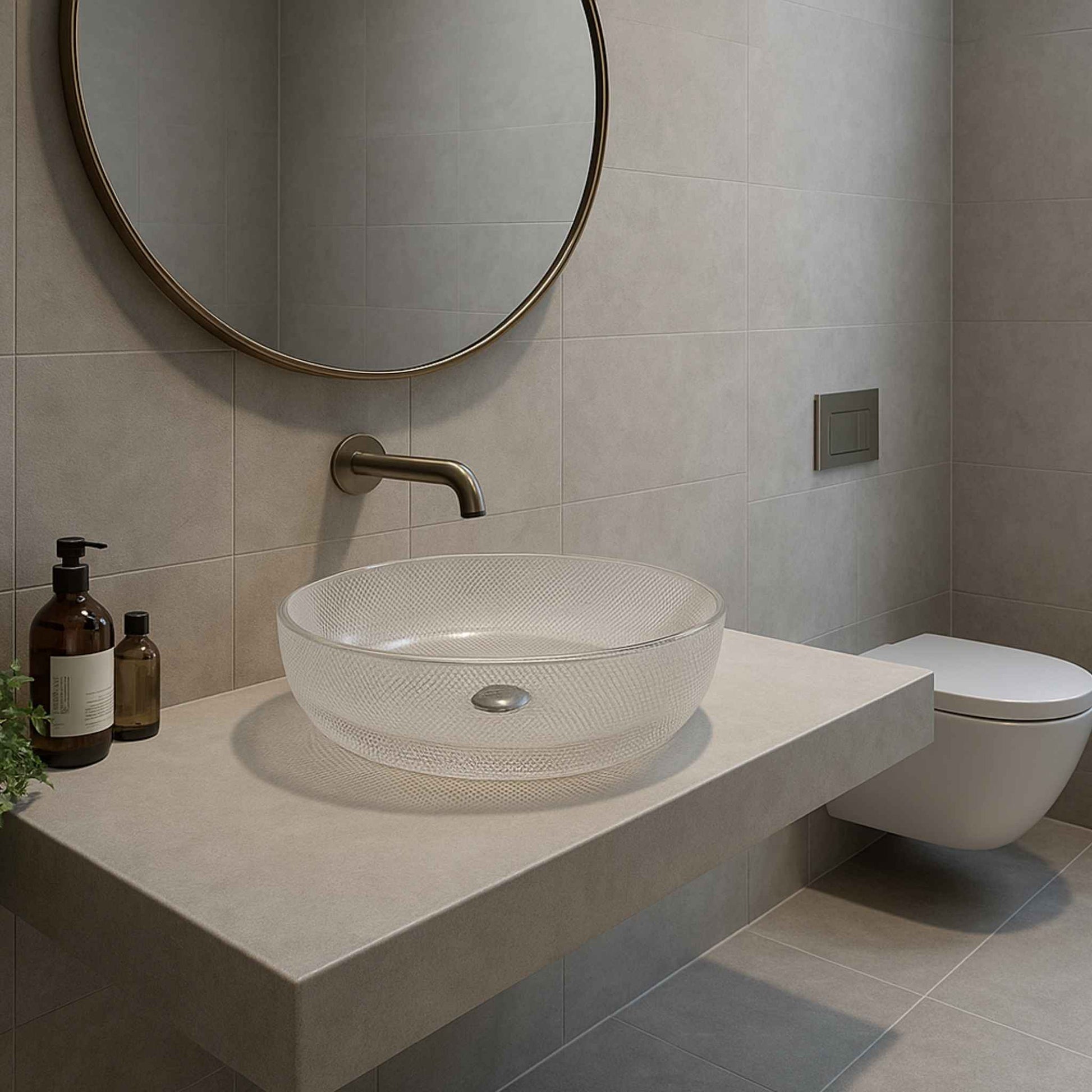 Modern bathroom with a glass sink, round mirror, and toiletries.