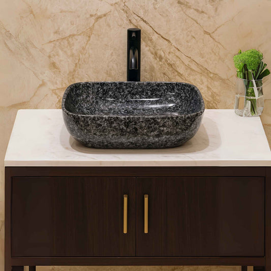 Glossy black granite wash basin in a luxury bathroom front view