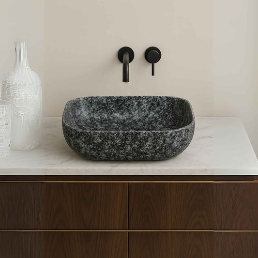 Front view of grey granite rectangular wash basin with matte black wall-mounted faucet