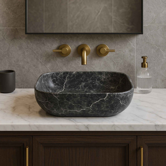 Front angle of grey stone finish marble countertop wash basin with luxury brass faucet on wooden bathroom vanity