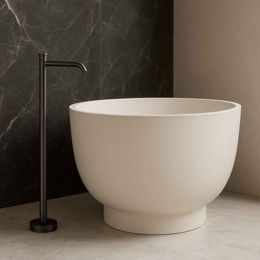 Gun metal floor mounted basin mixer tap beside a luxurious pedestal in a modern bathroom