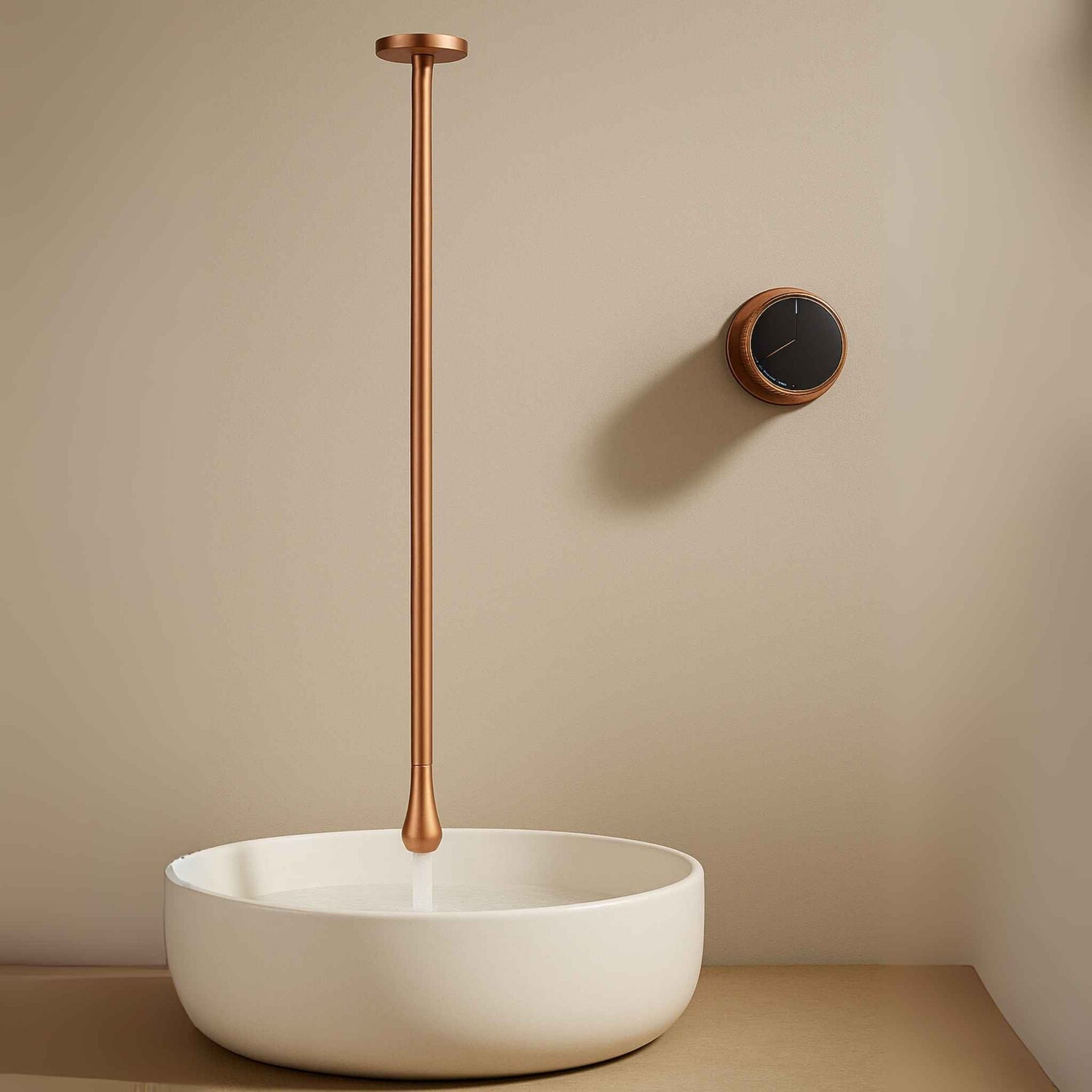 Front angle view of gun rose gold ceiling mounted basin mixer in a luxurious modern bathroom
