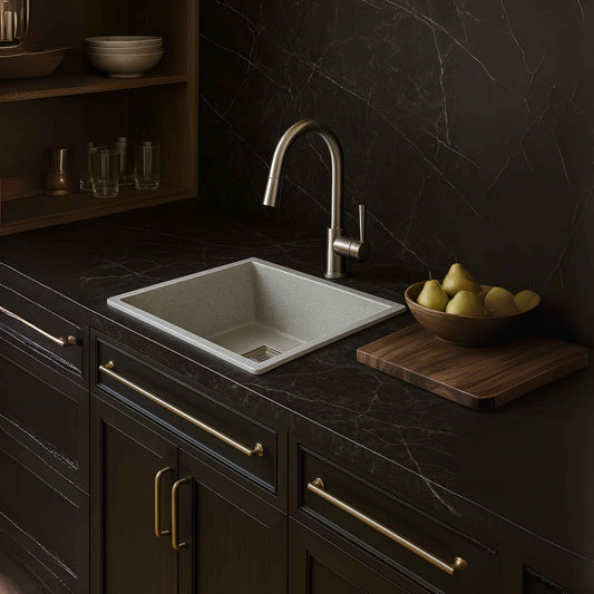 Full modular kitchen setup with light grey granite sink and dark Italian marble
