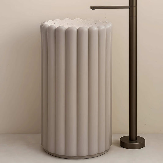 Front view of glossy lilac pedestal washbasin with scalloped rim and wall faucet