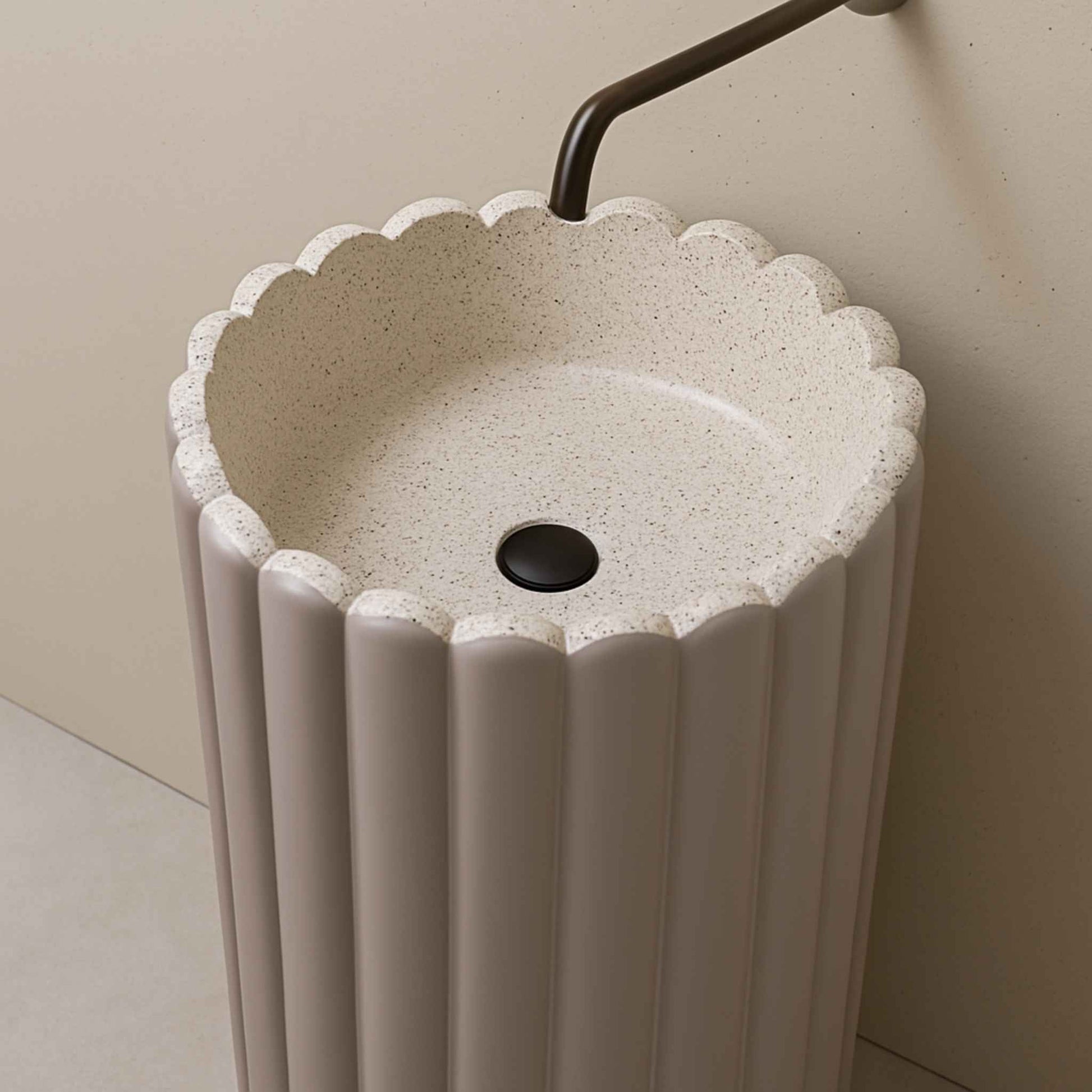 Top angle of scalloped lilac pedestal basin with overhead faucet