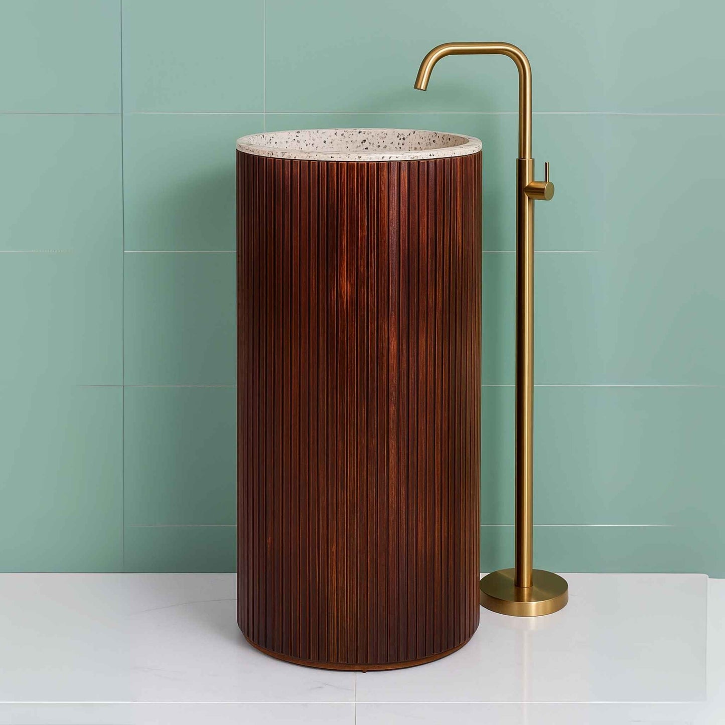 Front view of a wooden fluted pedestal washbasin with terrazzo top and a sleek gold faucet in a premium bathroom interior.