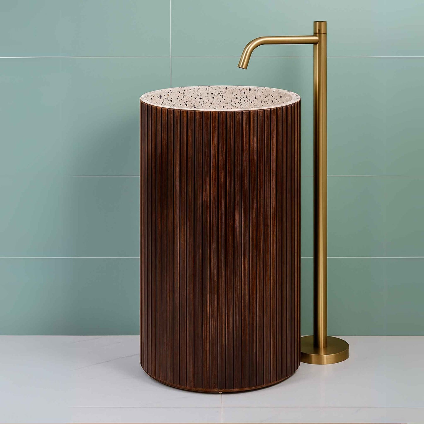 Side profile of a luxurious fluted wooden pedestal basin with terrazzo detailing, paired with a gold faucet and soft lighting.