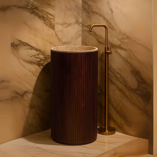 A luxurious modern bathroom with a wooden fluted pedestal washbasin as the focal point, complemented by terrazzo finish and golden tap.