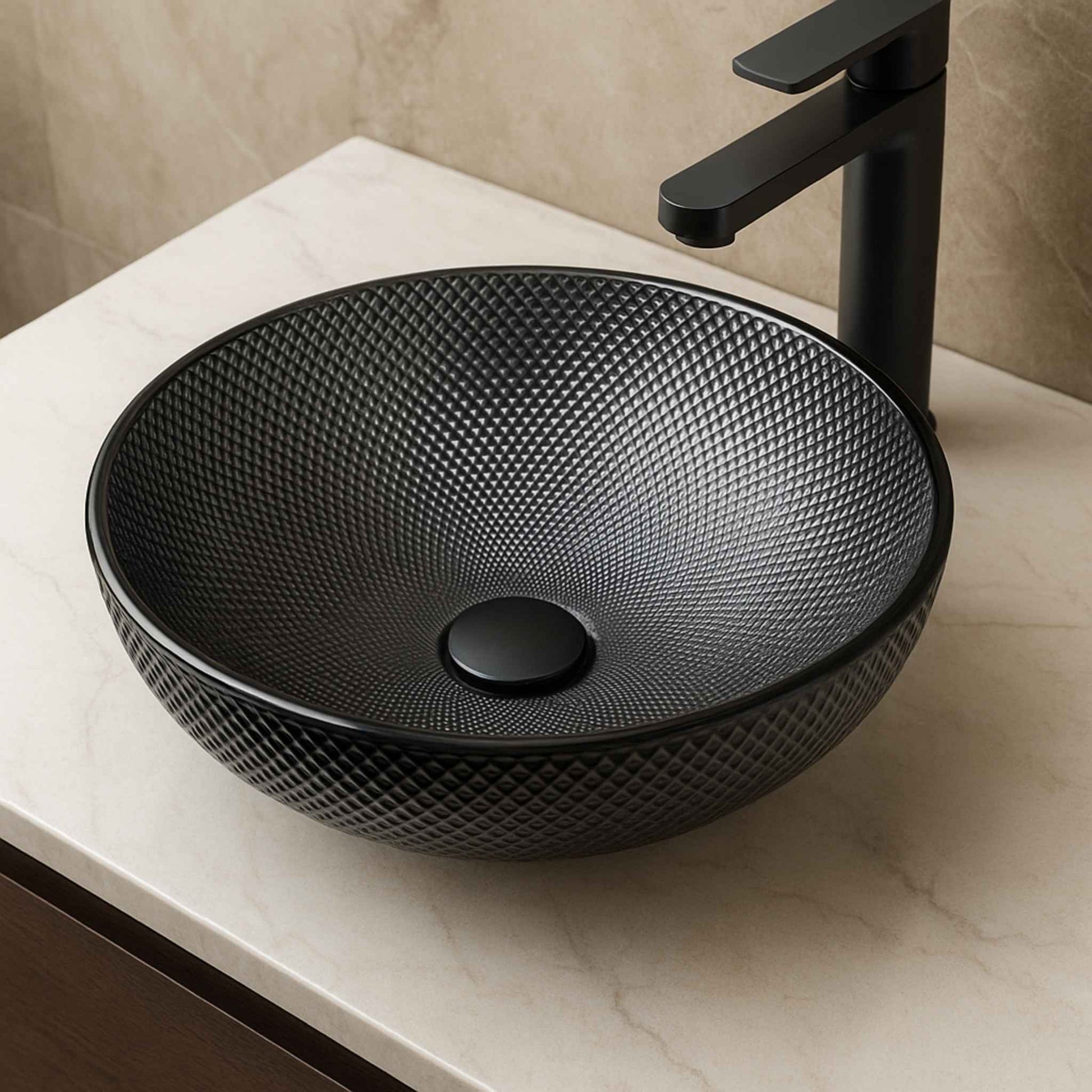 Luxury bathroom interior featuring textured black glass wash basin with gold faucet on black marble top