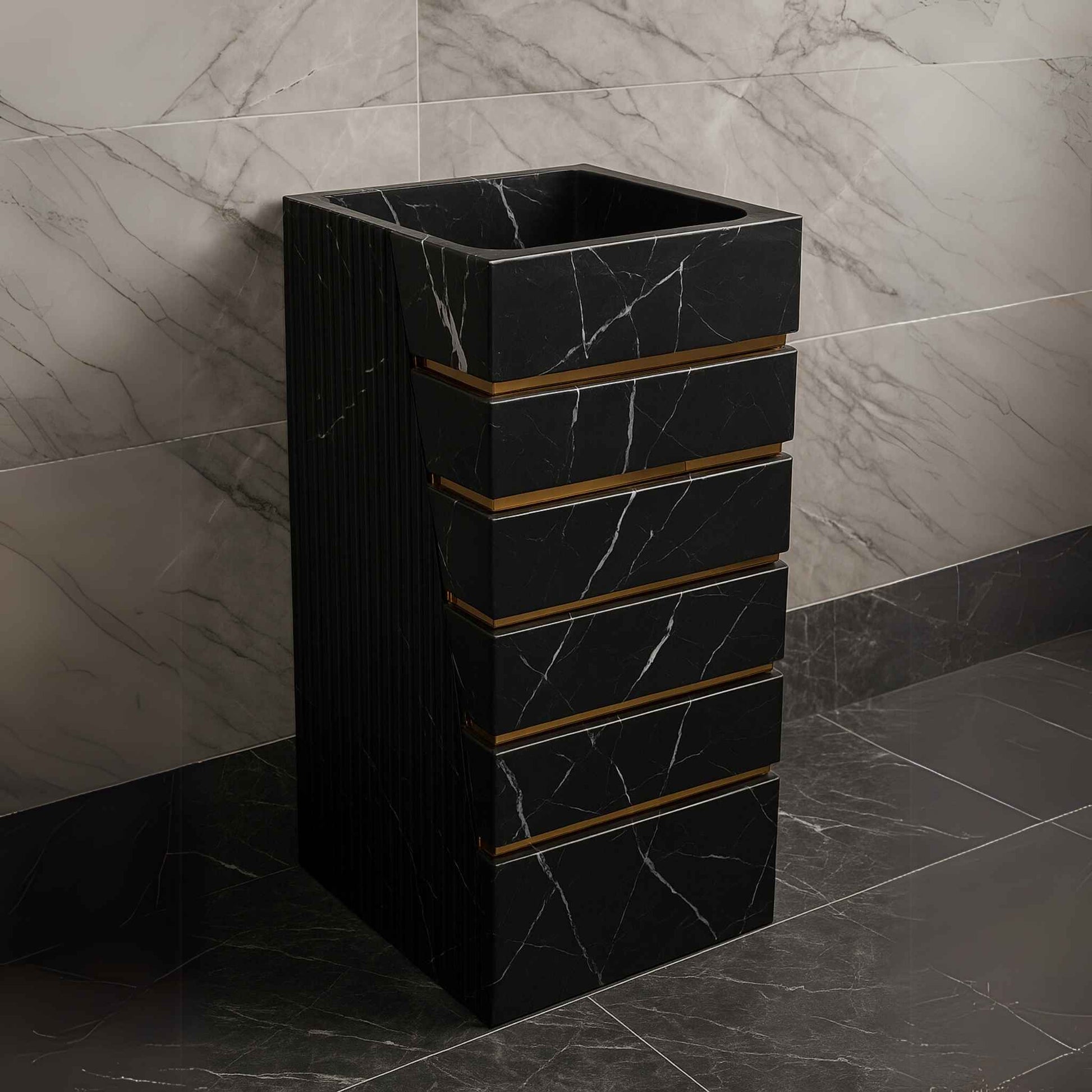 Black designer washbasin placed in luxury setting with dark marble tiles and gold fittings