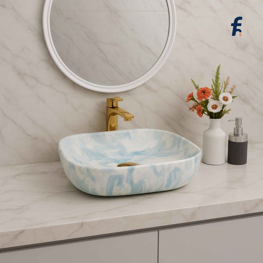 Bathroom vanity with a marble-patterned sink, gold faucet, and decorative elements, Full vanity setup with blue marble ceramic wash basin.