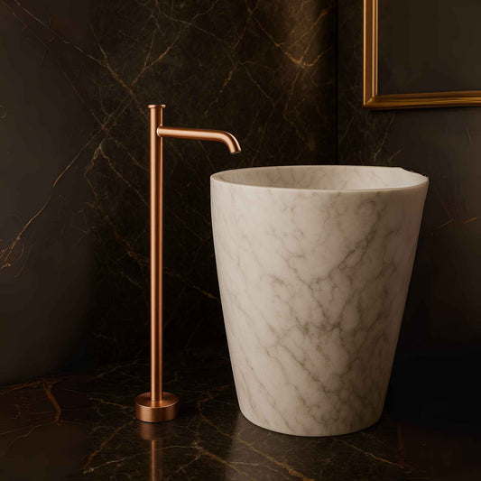 Full bathroom with brushed rose gold floor-mounted mixer and marble accents