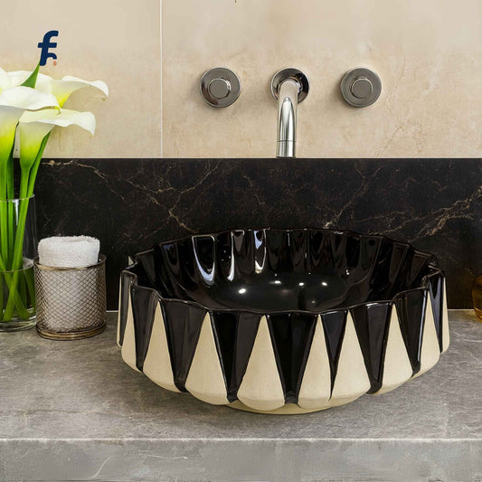 Black and white patterned sink on a bathroom counter with decorative elements.