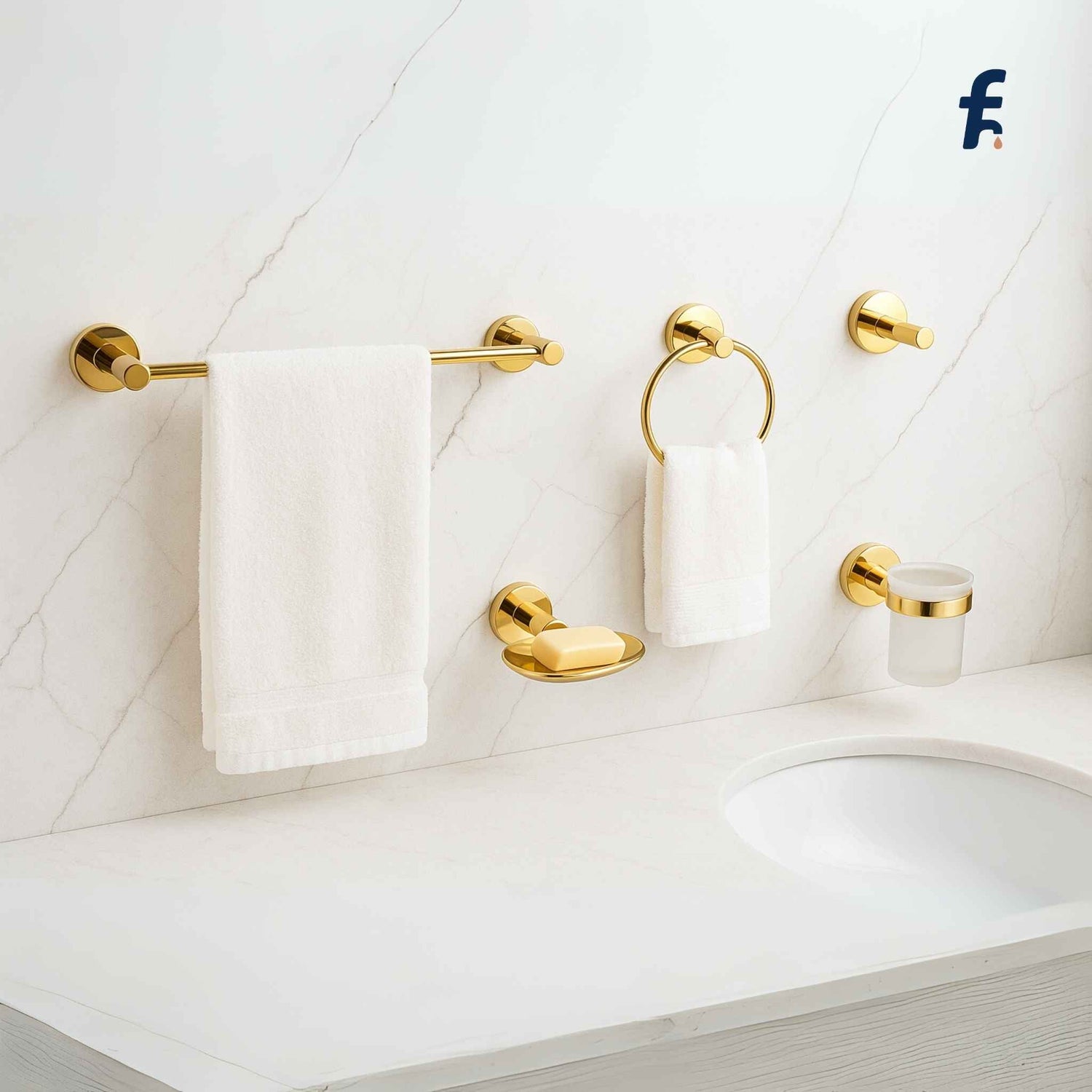 Gold bathroom accessories including a towel rack, holder, and soap dish on a white tiled wall. Premium gold bathroom accessory set with towel bar, napkin ring, robe hook, soap dish, and tumbler holder installed in a luxurious bathroom.