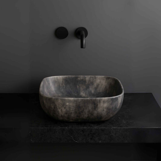 matte black marble finish rectangular wash basin placed on modern vanity
