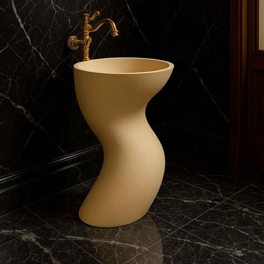 Side angle of a luxury beige sculptural washbasin with golden faucet, styled in a premium dark marble bathroom interior.
