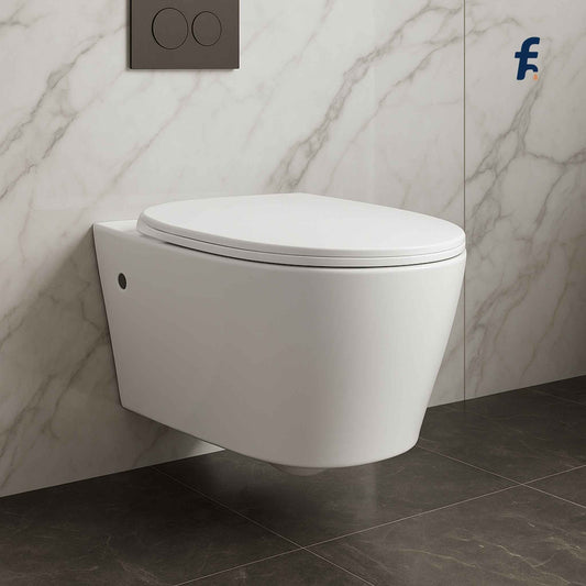 Wall-mounted white toilet in a bathroom with marble walls and dark tiles. Modern luxury wall hung toilet front view with marble flooring
