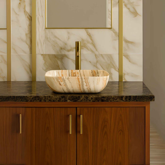 Front view of marble finish rectangular countertop wash basin placed on a luxurious bathroom vanity