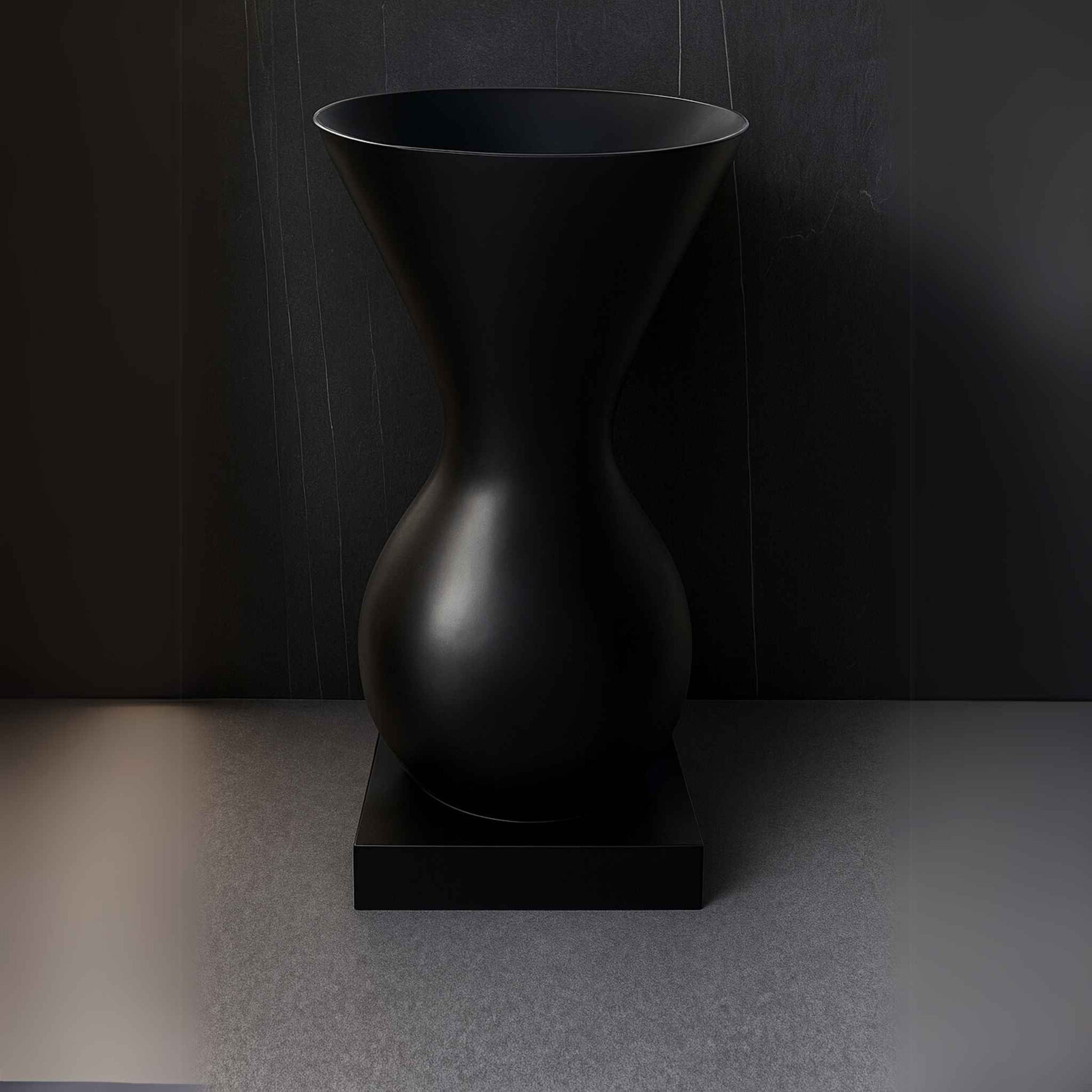 Front view of matte black hourglass pedestal washbasin with sculptural design, ideal for luxury bathrooms.