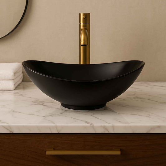  Front view of matte black oval tabletop wash basin placed on white marble – 540x370x170mm designer sink
