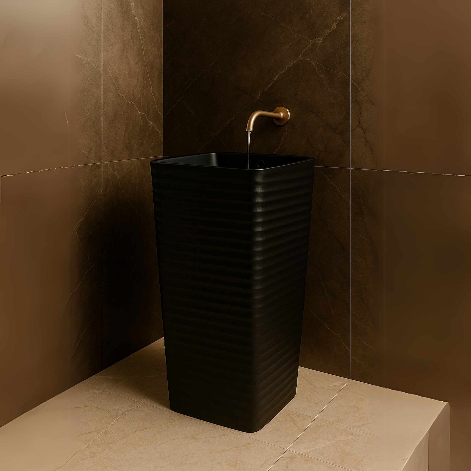 Front view of matte black ripple pedestal washbasin in marble bathroom