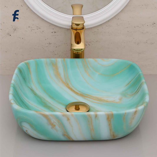 Marble-patterned sink with gold faucet against a neutral wall, Close-up shot of mint green marble wash basin with gold faucet
