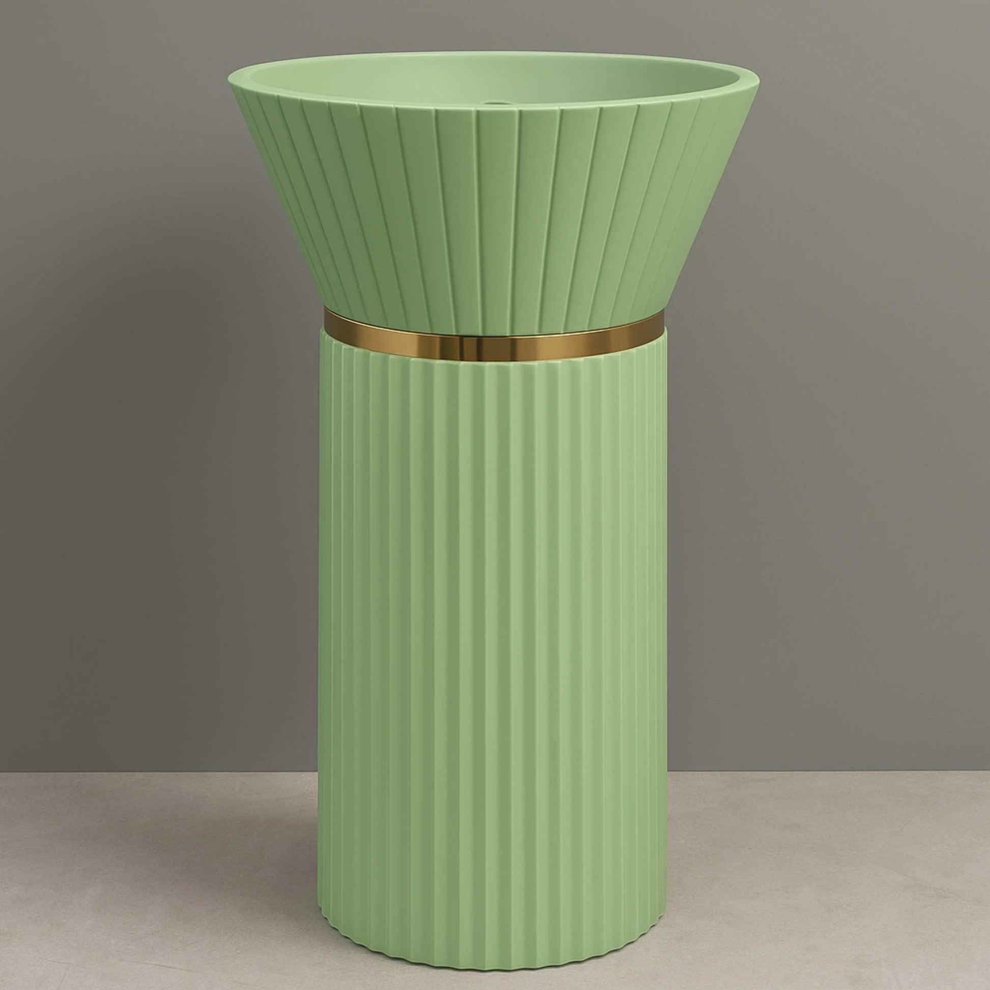 Front-facing view of mint green pedestal wash basin with fluted body