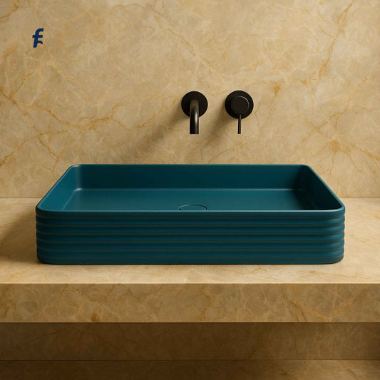 Blue rectangular sink on a beige marble countertop with black faucet and handles.