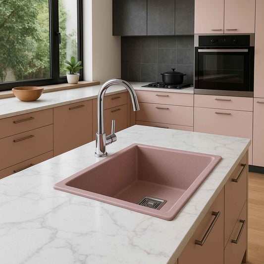 Pink granite kitchen sink integrated into a luxury modular kitchen with Italian marble top and chrome fittings.