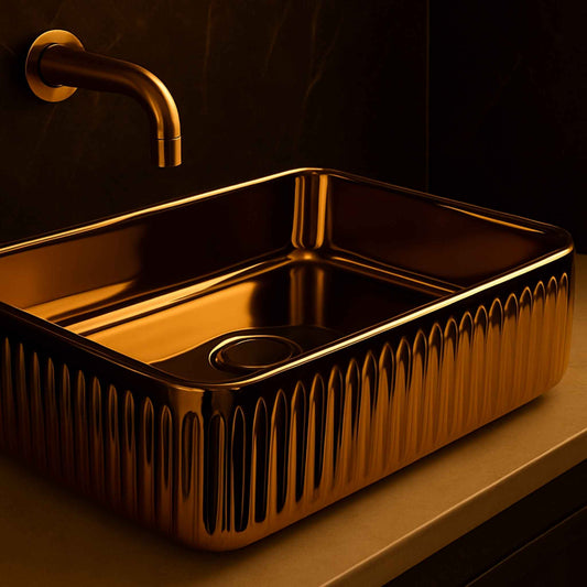 Gold sink with a matching faucet on a dark background