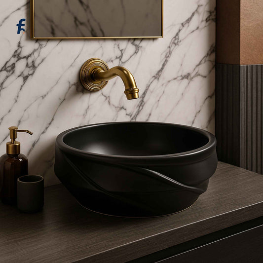 Side angle of modern black vessel sink with designer sculpted base