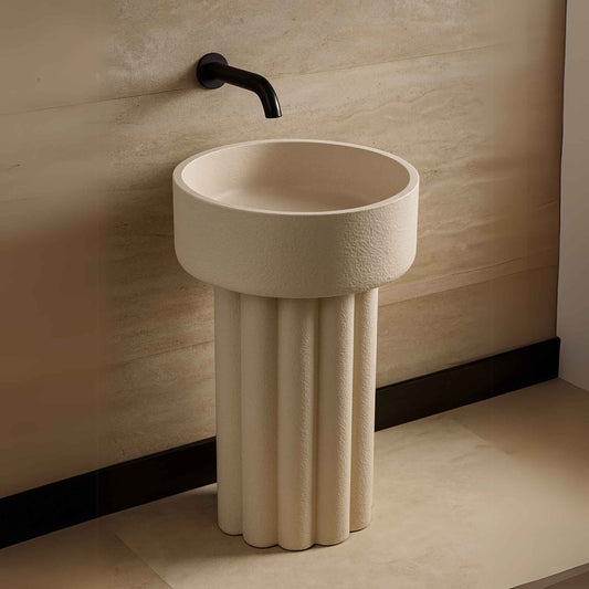 Side angle of freestanding stone pedestal sink with wall-attached faucet