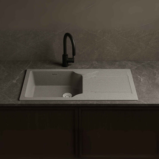 Front view of silver granite kitchen sink placed in a luxurious kitchen with Lizard Grey marble.