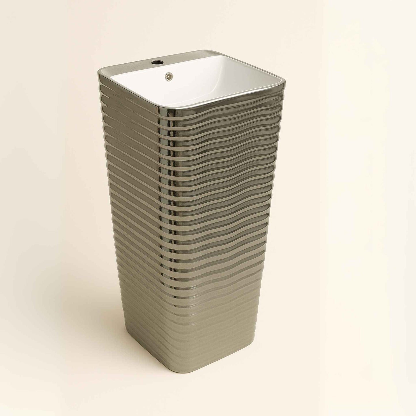 Side angle showing horizontal ripple finish on silver pedestal basin